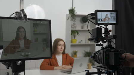 Filming of the TV show, behind the scenes. Recording of a TV show with a female TV presenter.