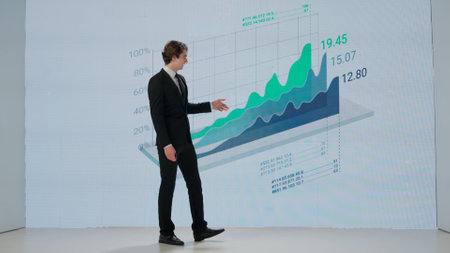 Man presenting project on stage during meeting. A businessman talks to the audience, shows...