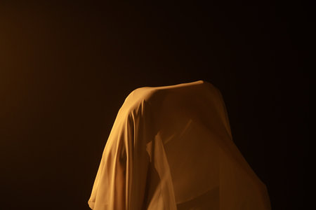 Young girl dancer in white chiffon on black background with emotional movements