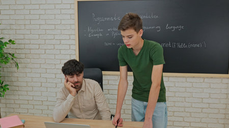 Student and Instructor Discuss Python Code in Modern Classroom