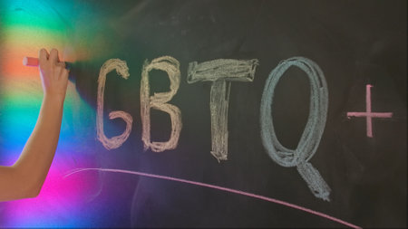 Close up of woman hand writing text letters lgbt with colorful chalks on chalkboard, Diversity and human relationships. Educational concept.の写真素材