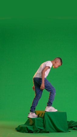 Young Boy Stepping Down on a green screen chroma keyの写真素材