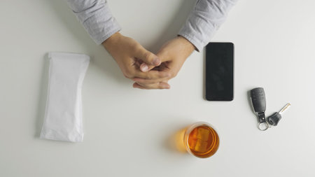 Top view of man puts an envelope with money bills on the table, smartphone and car keys at the side.の写真素材