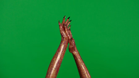 Creepy halloween monster hand in glitter slime with nails shows applause gesture clapping hands isolated on chroma key green screen background, workspace mockup.の写真素材