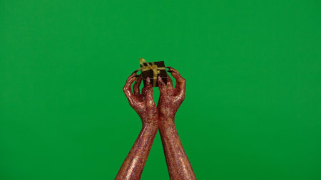 Creepy halloween monster hand in glitter slime with nails holding small box, isolated on chroma key green screen background, workspace mockup.の写真素材