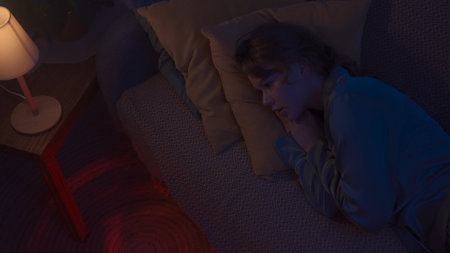Woman in pajama sleeping in bed in dark apartment room, monster hiding under bed. Girl waking up...