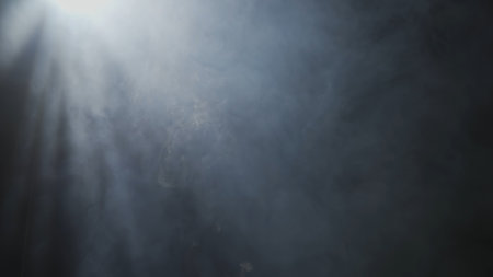 Soft diffused rays of light cut through the hazy darkness.の写真素材