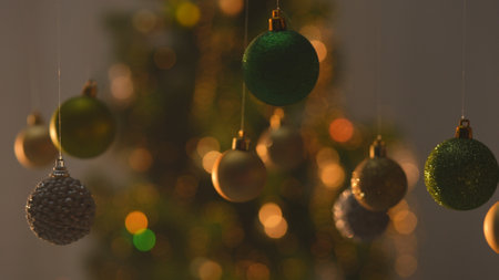 Christmas tree golden green silver balls, sparkling toys hanging from above, glittering ornaments...