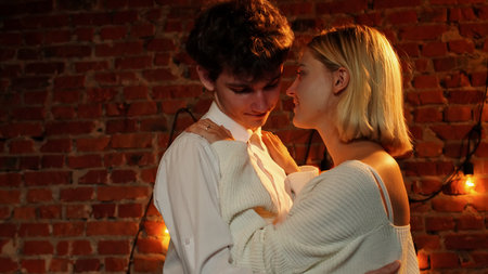 Couple celebrating valentines day and having a romantic dinner in restaurant, close up shot of man and woman dancing holding hands, enjoying music.の写真素材