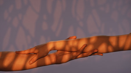 Man and woman hands showing gestures, touching and holding, isolated on studio background with warm light pattern effect, close up shot. Valentines day advertising concept.の写真素材