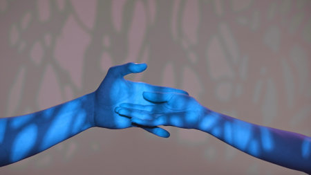 Man and woman hands showing gestures, touching and holding, isolated on studio background with blue light pattern effect, close up shot. Valentines day advertising concept.の写真素材