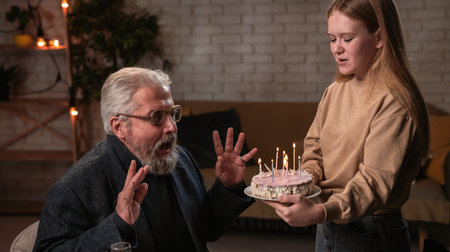 Family sit at table at home, grandchildren and parents celebrating birthday of grandfather, family...