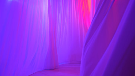 Transparent silk curtains in pink and purple neon light hanging from top, floating from an open window, shadows reflected on the textile.の写真素材
