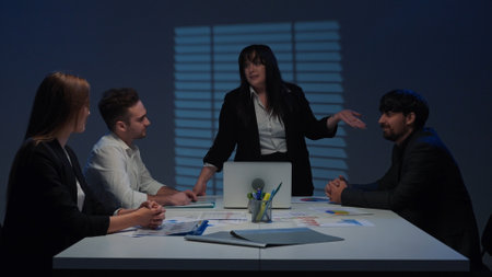 Woman chief executive leads meeting with colleagues in boardroom at desk, closing project discussing...