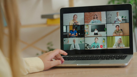 Woman college student studying at home, watching lesson online on laptop, screen shows teacher...