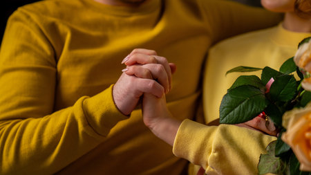 Happy couple celebrating valentines day together at home, man and woman sitting on the sofa and...