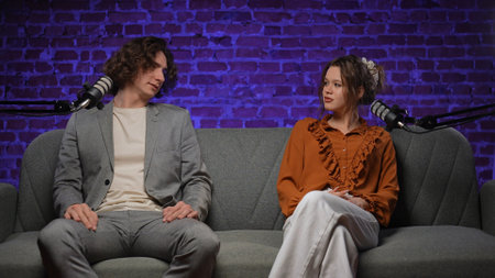 Engaging Conversation Unfolds in a Vibrant Podcast Studio Settingの写真素材