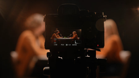 Engaging Dialogue Unfolds in Intimate Studio Setting During Vibrant Podcast Recording Sessionの写真素材