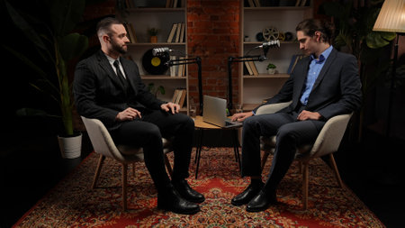 Two experts talking in a cozy, loft-style podcast studio