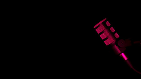 Studio microphone with dramatic pink lightingの写真素材