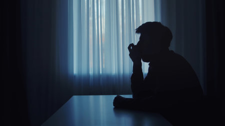 Dark silhouette of a man inhaling aerosol.の写真素材