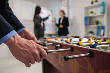 Office Professionals Playing Foosball During a Break in the Workplaceの写真素材