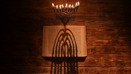 Candlelight Dance of Shadows During Hanukkah Celebrations With a Vintage Menorahの写真素材