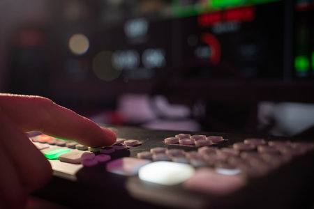 Finger Pressing Button on Control Panel with Blurred Background