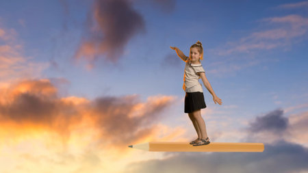 Child Imagines Flying on Giant Pencil in the Skyの写真素材