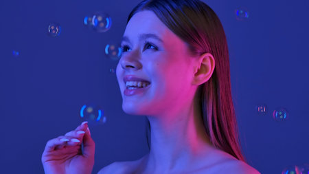Portrait of Woman with Bubbles and Blue Backgroundの写真素材