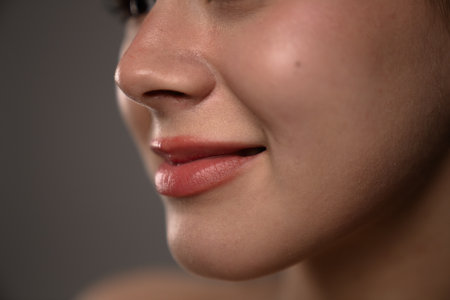 Close Up Photograph of Womans Soft Skin with Subtle Smileの写真素材