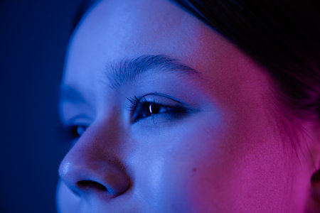 Close Up Portrait in Blue and Pink Lighting with Focus on Eyeの写真素材
