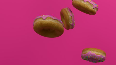 Floating donuts with pink icing against a vibrant backgroundの写真素材