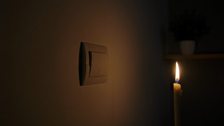 Dimly Lit Room with Candle and Light Switch on Wall