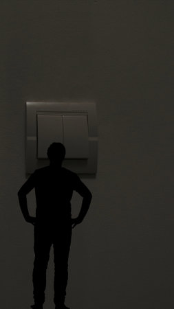 Silhouette of a Man Looking at a Large Switchの写真素材