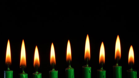 Hanukkah Menorah with Lit Candles Displayed on Black Backgroundの写真素材