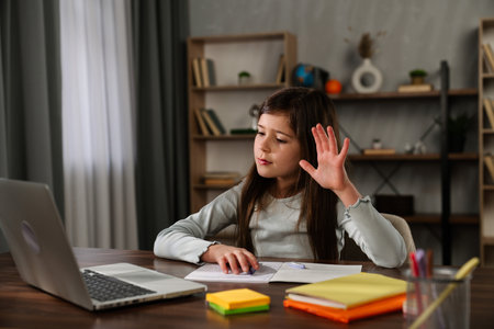 Young Woman Studying at Wooden Deskの写真素材