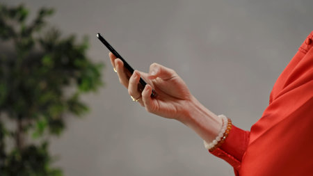 View of a Person Holding a Smartphone Deviceの写真素材