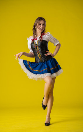 Woman in Traditional Dress Posing with Yellow Backgroundの写真素材