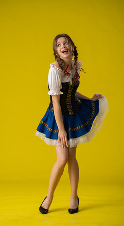 Woman in Traditional Dress Posing with Yellow Backgroundの写真素材