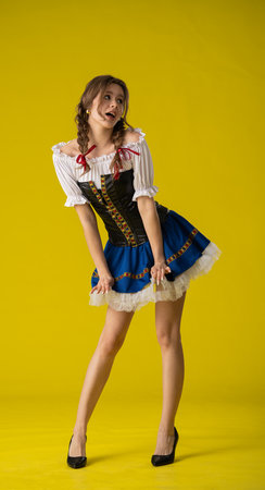 Woman in Traditional Dress Posing with Yellow Backgroundの写真素材
