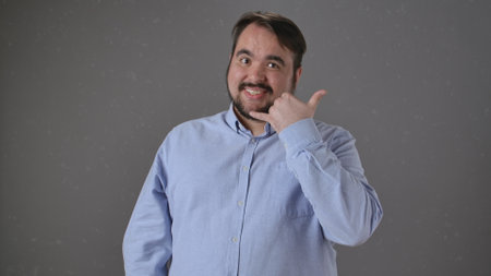Friendly man making a phone gesture with his hand