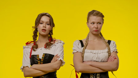 Two Women in Traditional Costumes with Braided Hairstylesの写真素材
