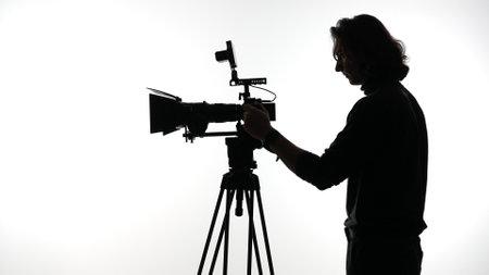 Silhouette of a Person Operating a Professional Film Cameraの写真素材