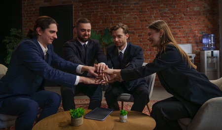 Team showing unity and cooperation in a modern office environmentの写真素材
