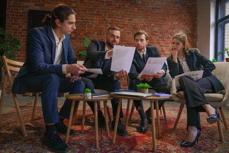 Business Team Analyzing Financial Documents in Modern Office Setting