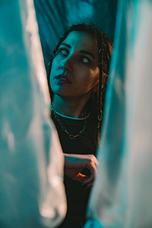 Contemplative Woman in Dramatic Blue Light Setting