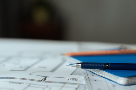 Architectural Blueprint with Wooden Ruler on Table