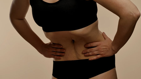 Woman in Black Lingerie Doing Stomach Vacuum Techniqueの写真素材