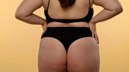 Detailed View of a Woman's Hip and Buttocks on Neutral Backgroundの写真素材